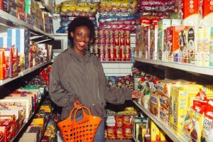 funny black woman choosing food in grocery shop 4177735 1024x682 1